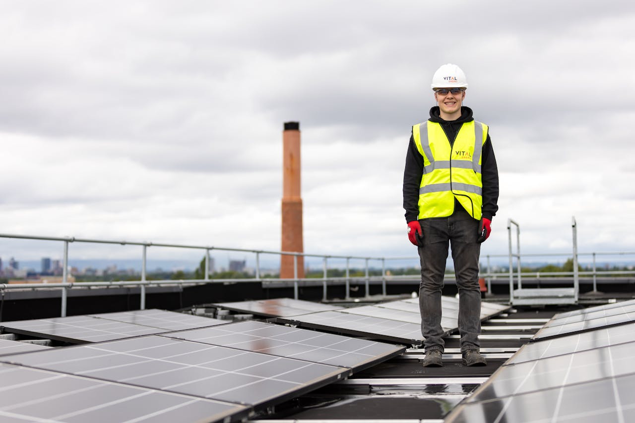 Engineer Standing among Solar Panels